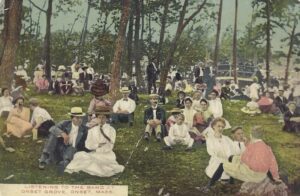 an old fashioned postcard picture of people enjoying music on the Onset Bluffs